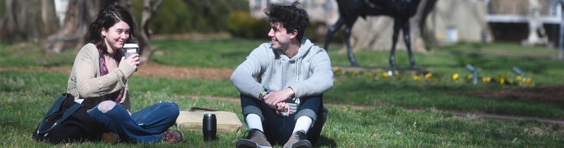 Two students drinking coffee on Belmont's Quad