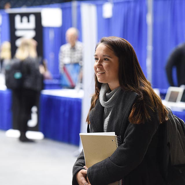 Student listening to internship opportunities during student job fair