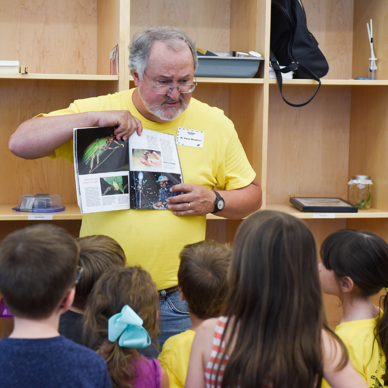 Dr. Murphree shows students a photo from a book