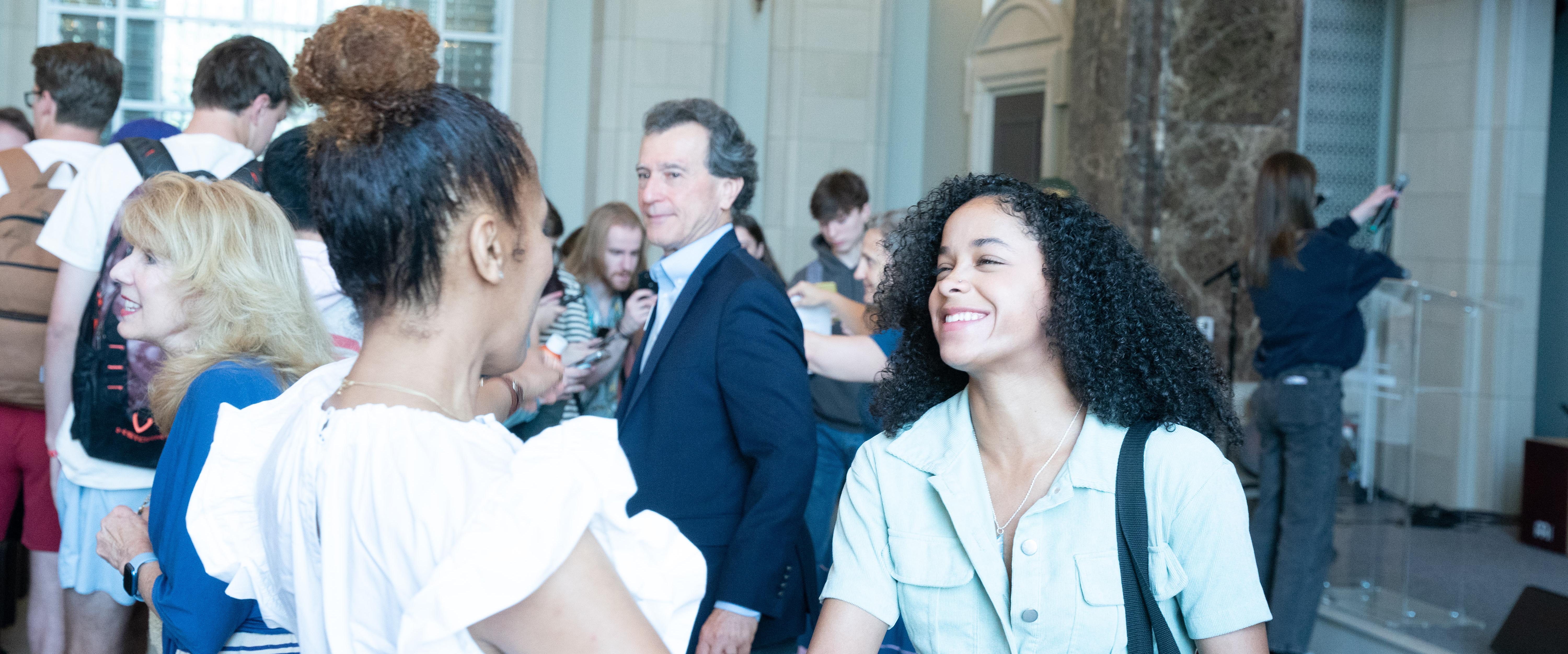 Student smiling and talking to Stacey Holman a