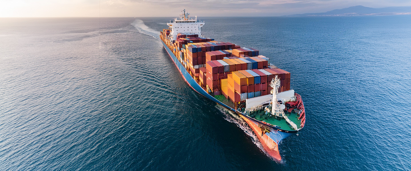 aerial view of a cargo ship carrying cargo containers on the ocean