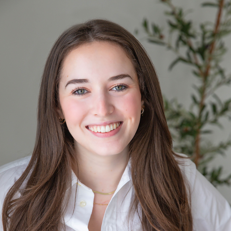 Headshot of Ansley Deaton in a white button down shirt in front of a neutral background