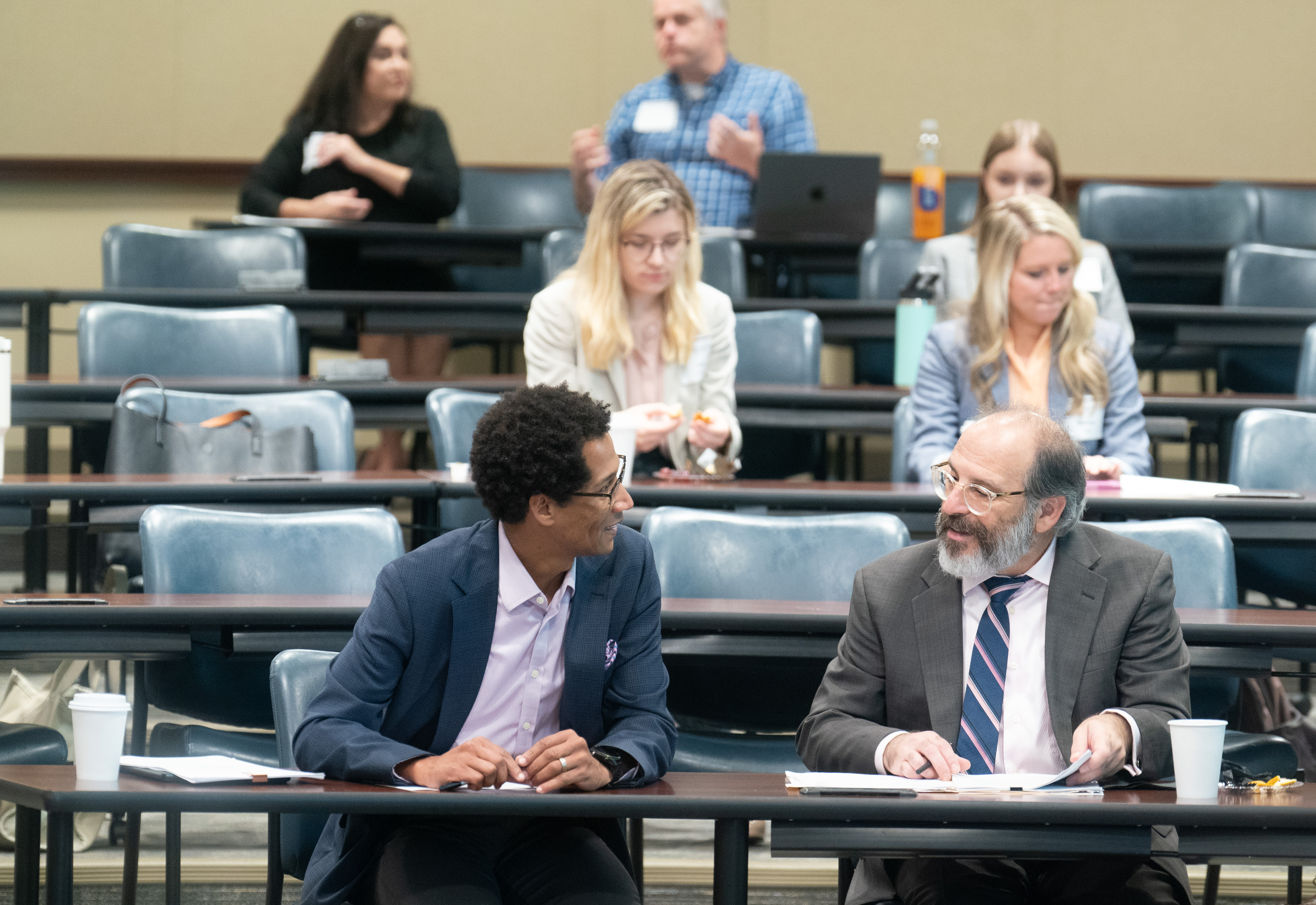 Attorneys talking at law symposium