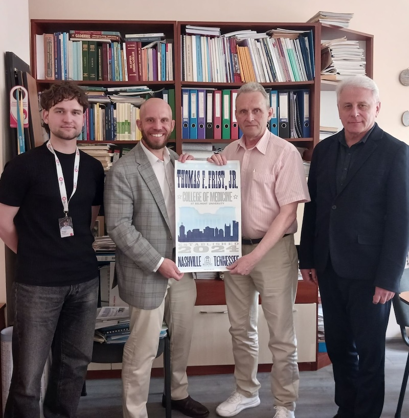 Four men holding a posting saying Thomas F. Frist Jr. College of Medicine