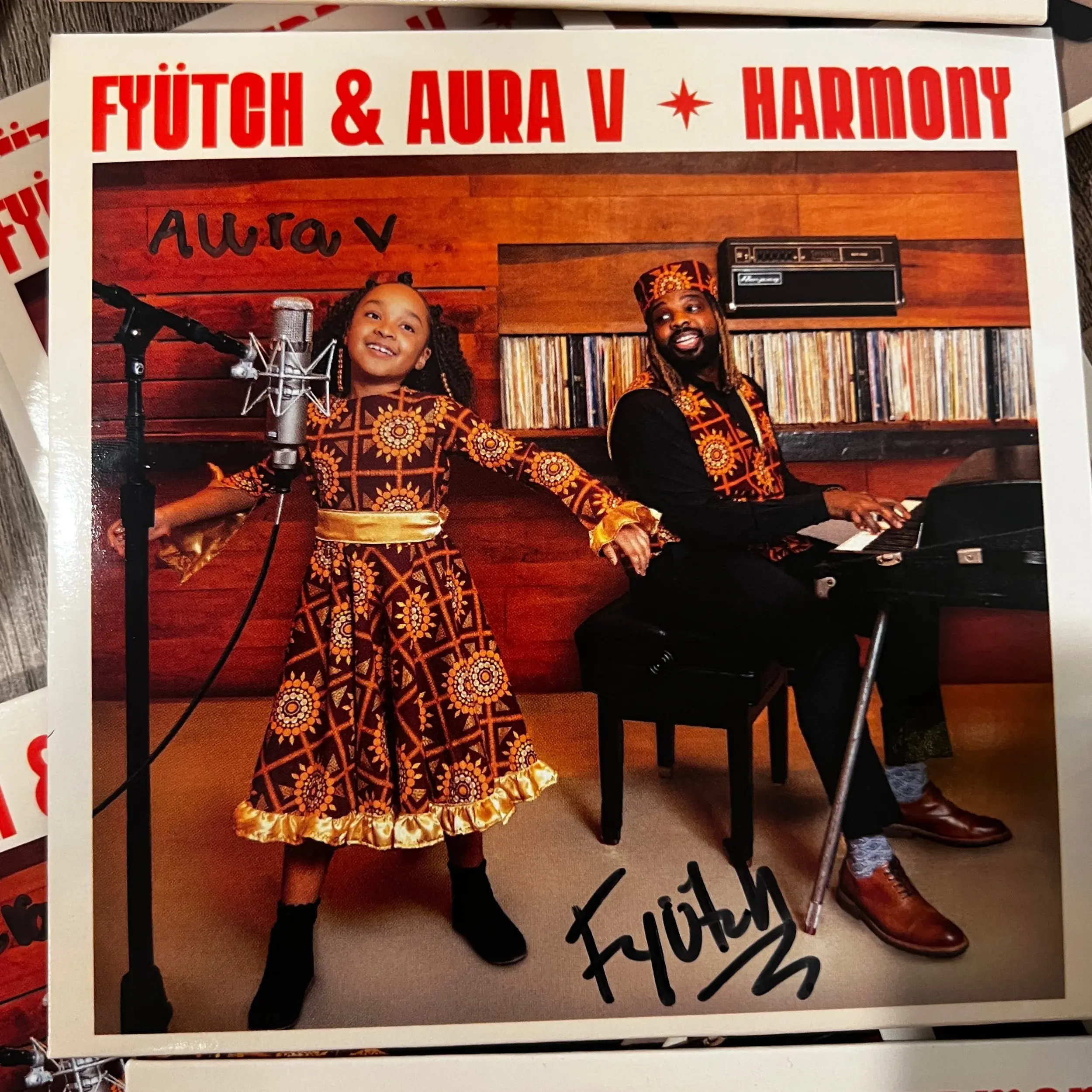 A signed copy of the album Harmony by Futch and Aura V.