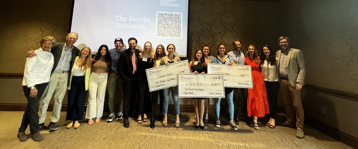 Student competitions pose with three competition finalists holding big checks