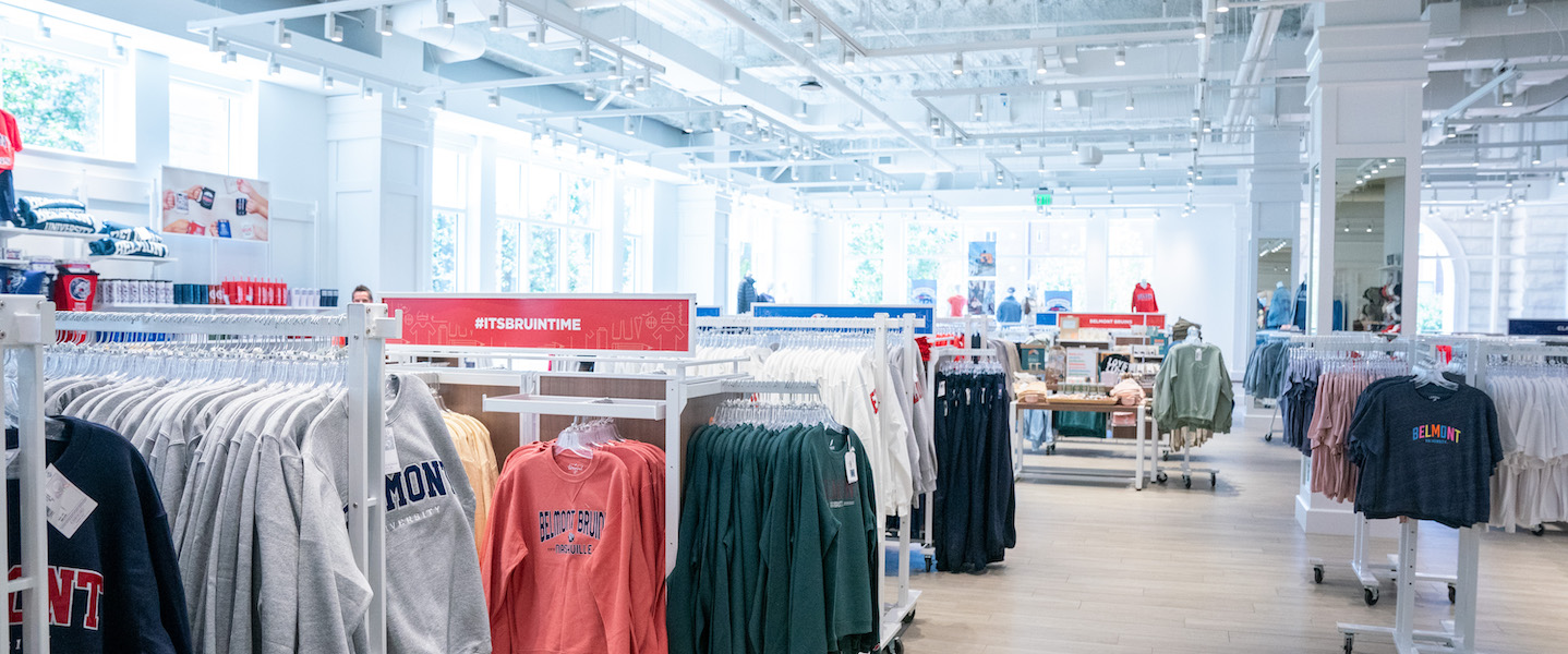 Image of a few racks in The BruinShop, featuring longsleeved and shortsleeved Belmont shirts