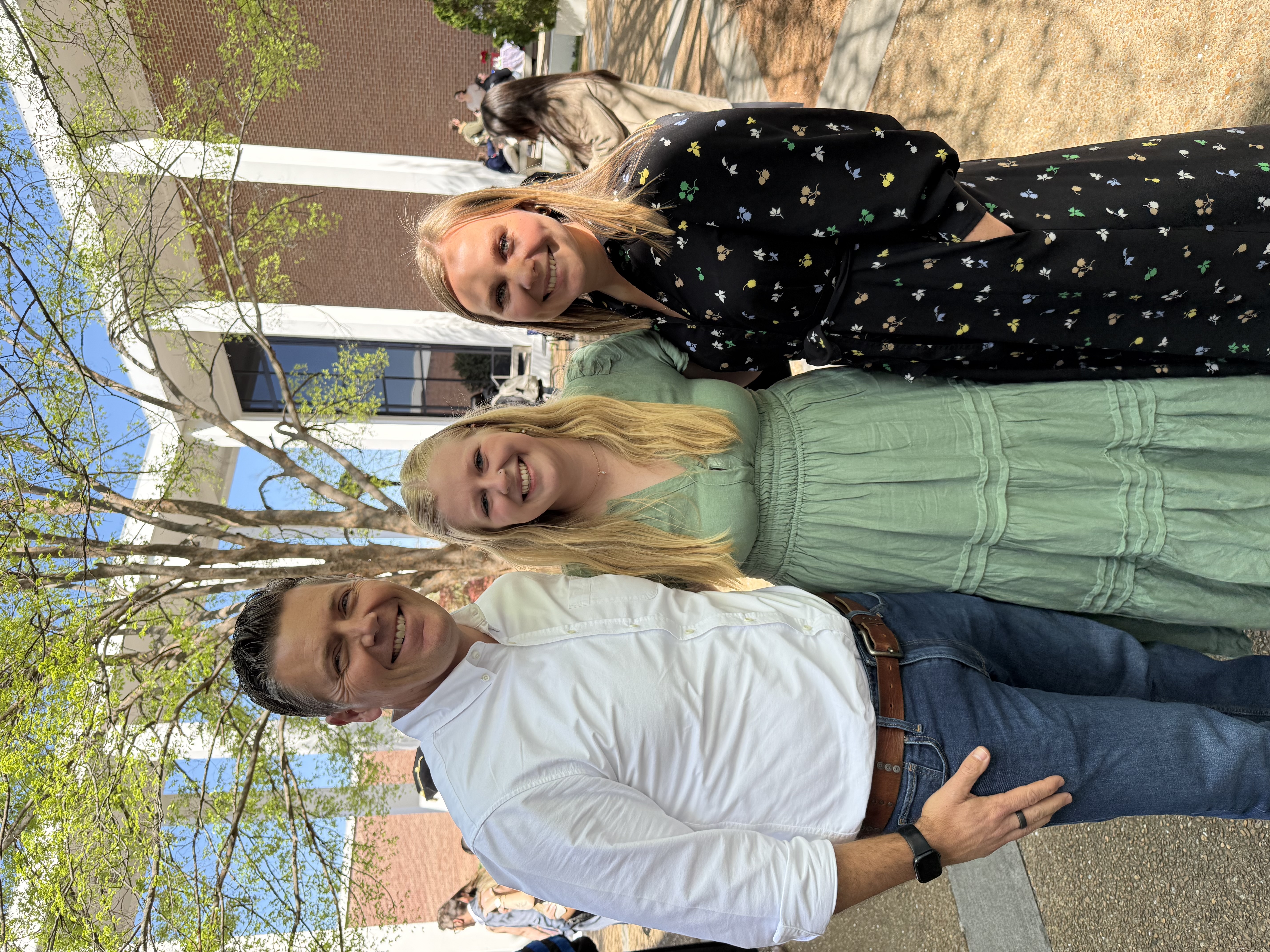 3 people standing outside of a building