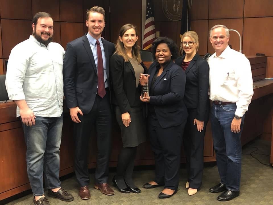 Mock trial students holding trophy
