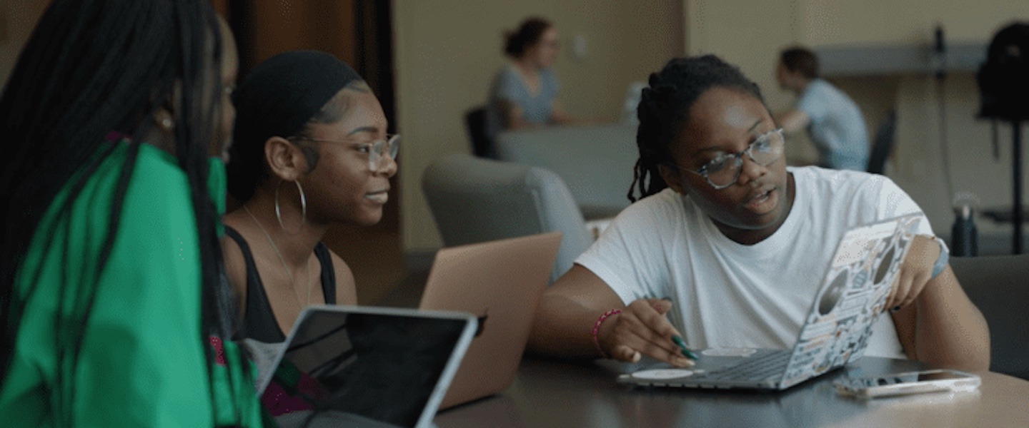 Miracle helping her friends on a computer