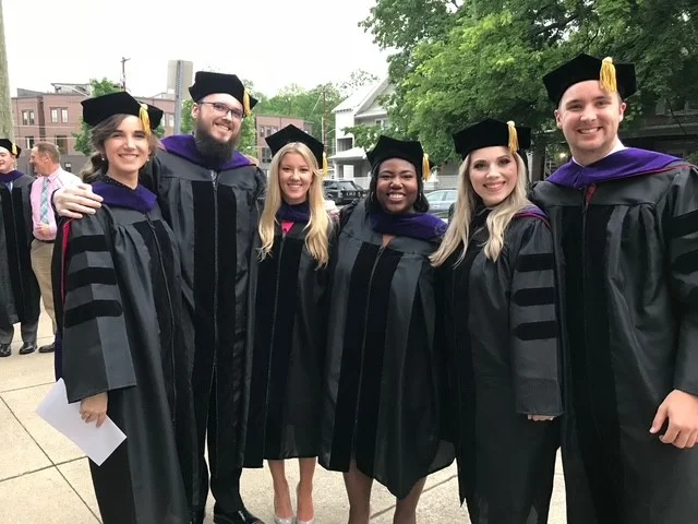 Law students in graduation cap and gown