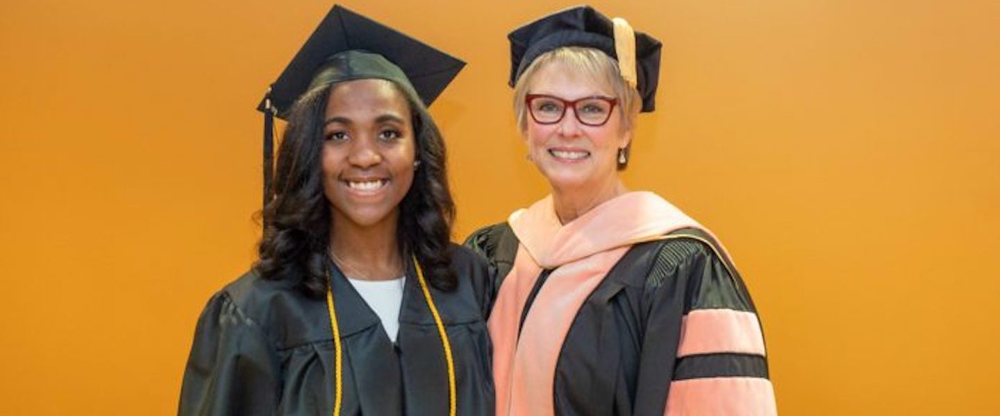 Shekinah McLaughlin and Dr. Cathy Taylor pose at Mclaughlin's graduation ceremony.