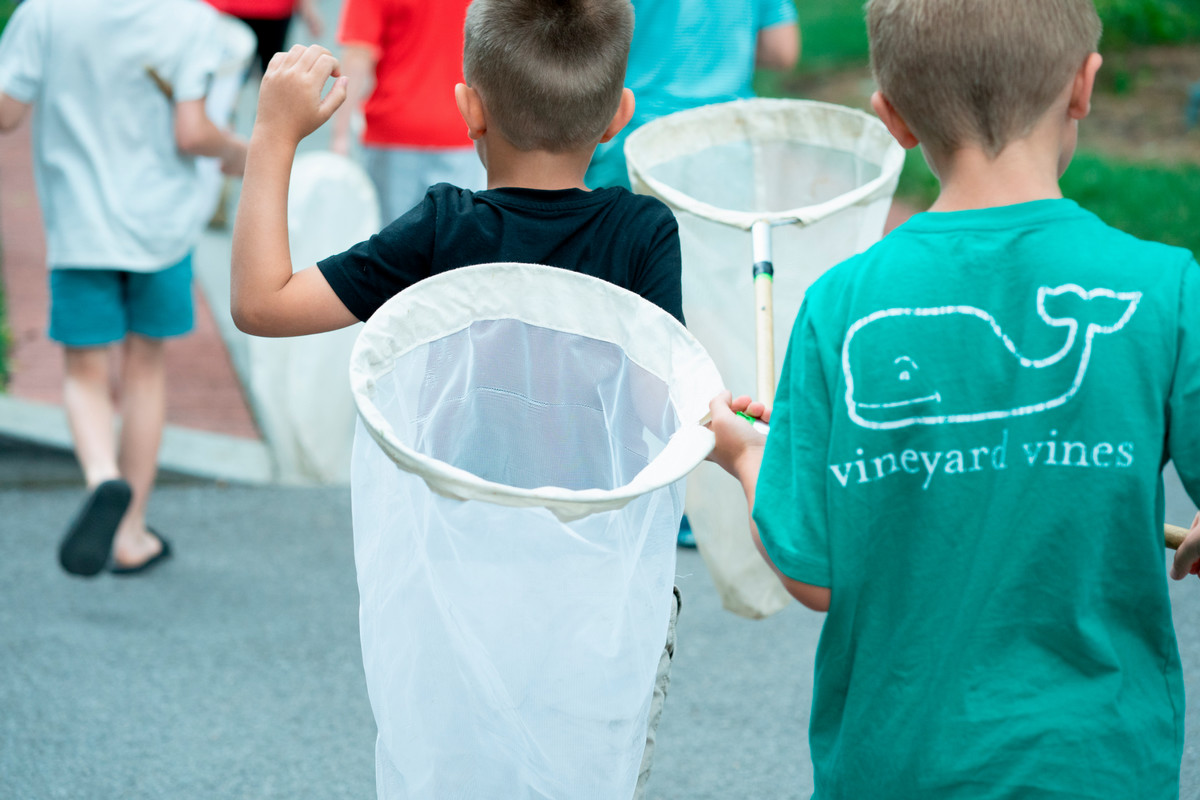 Two campers walk with nets