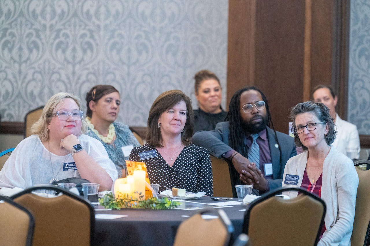 Attendees of the Honorable Life dinner sit at round tables watching the speaker.