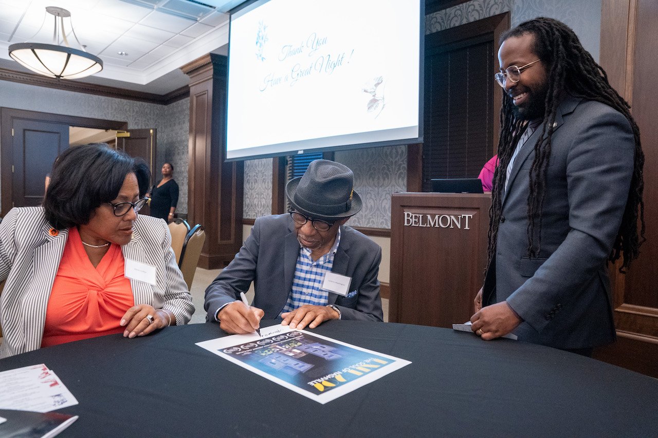 Lorenzo Washington signing a poster