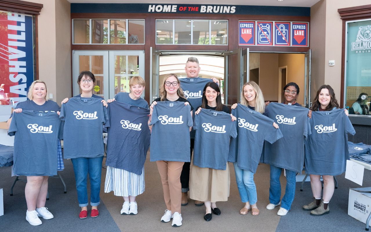 Belmont staff members hold up SOUL t-shirts