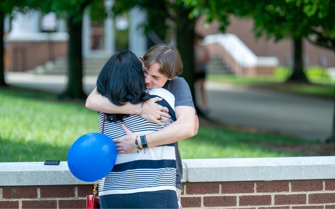 New student hugs family member before they leave