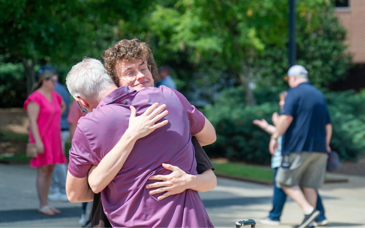 New student hugs family member before they leave