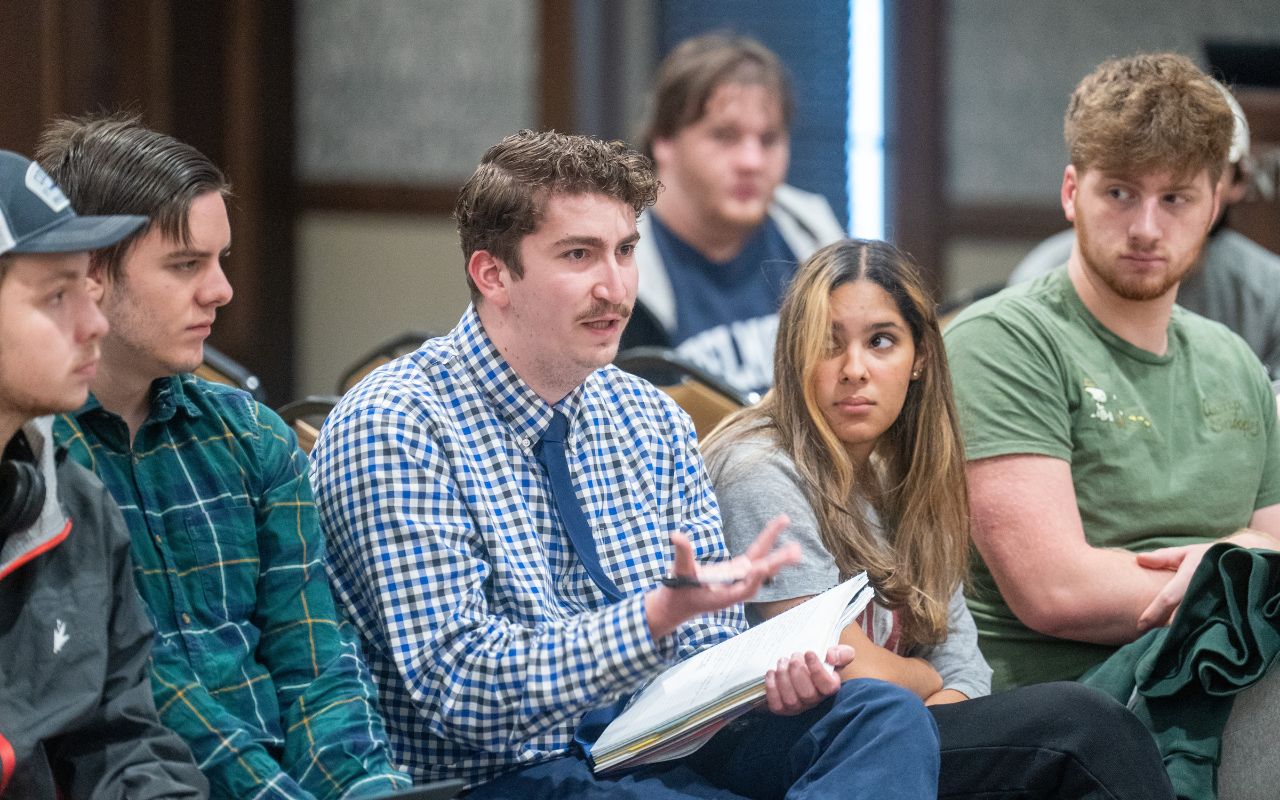 Students discuss in a circle