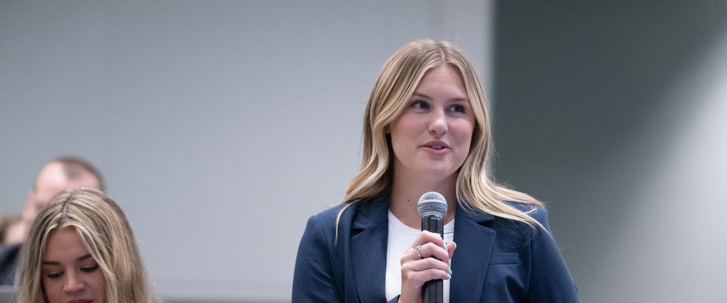 Caitlyn Luce speaks in front of the class