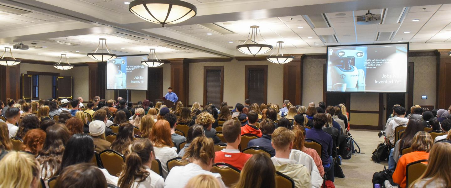 Conference room full of students attending computer science lecture