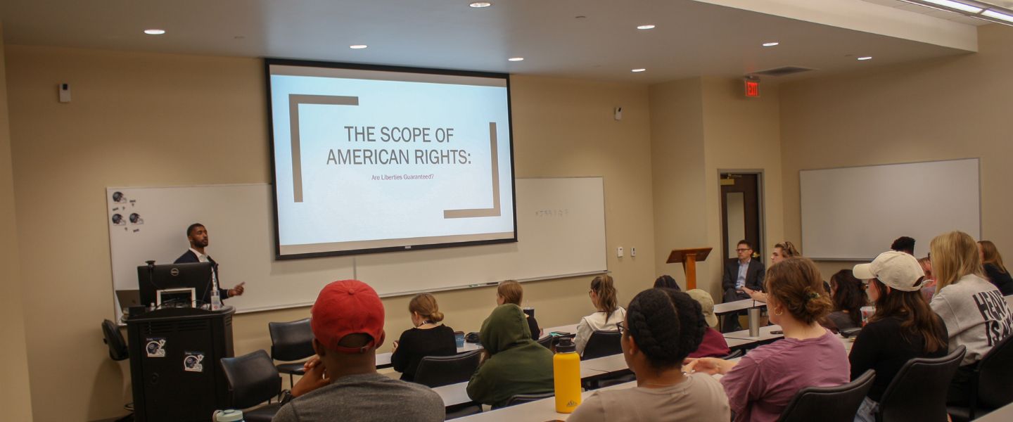 Speaker talks in front of a classroom about the scope of American rights