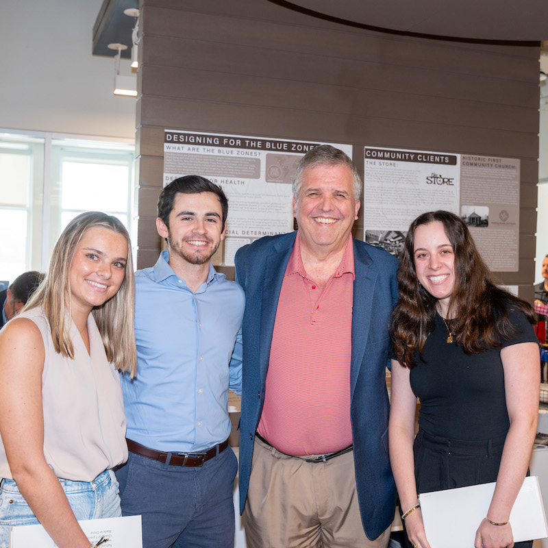 Architecture students standing with University President Dr. Greg Jones