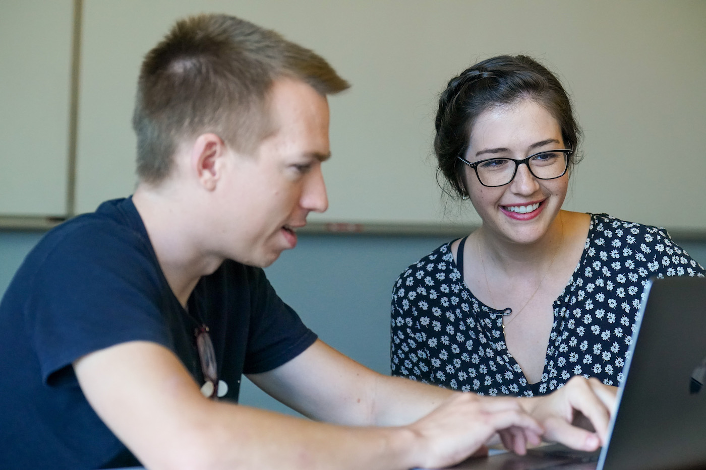 Davis works with student on computer