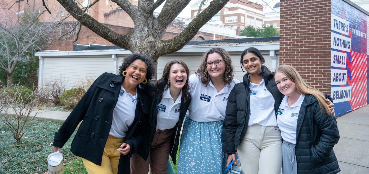 Belmont staff pose outside on campus by the Curb center.