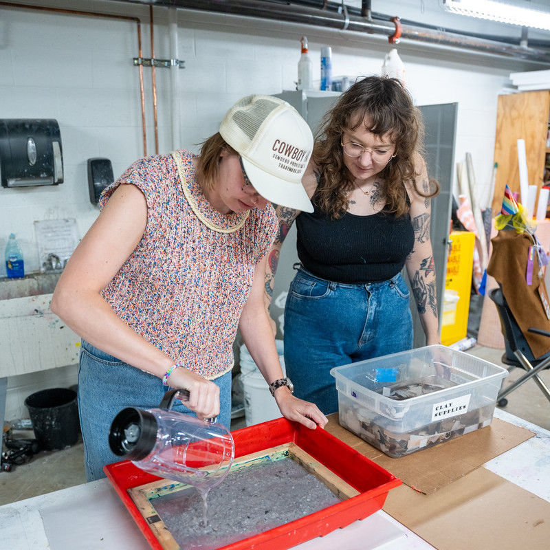 students work with materials in art studio