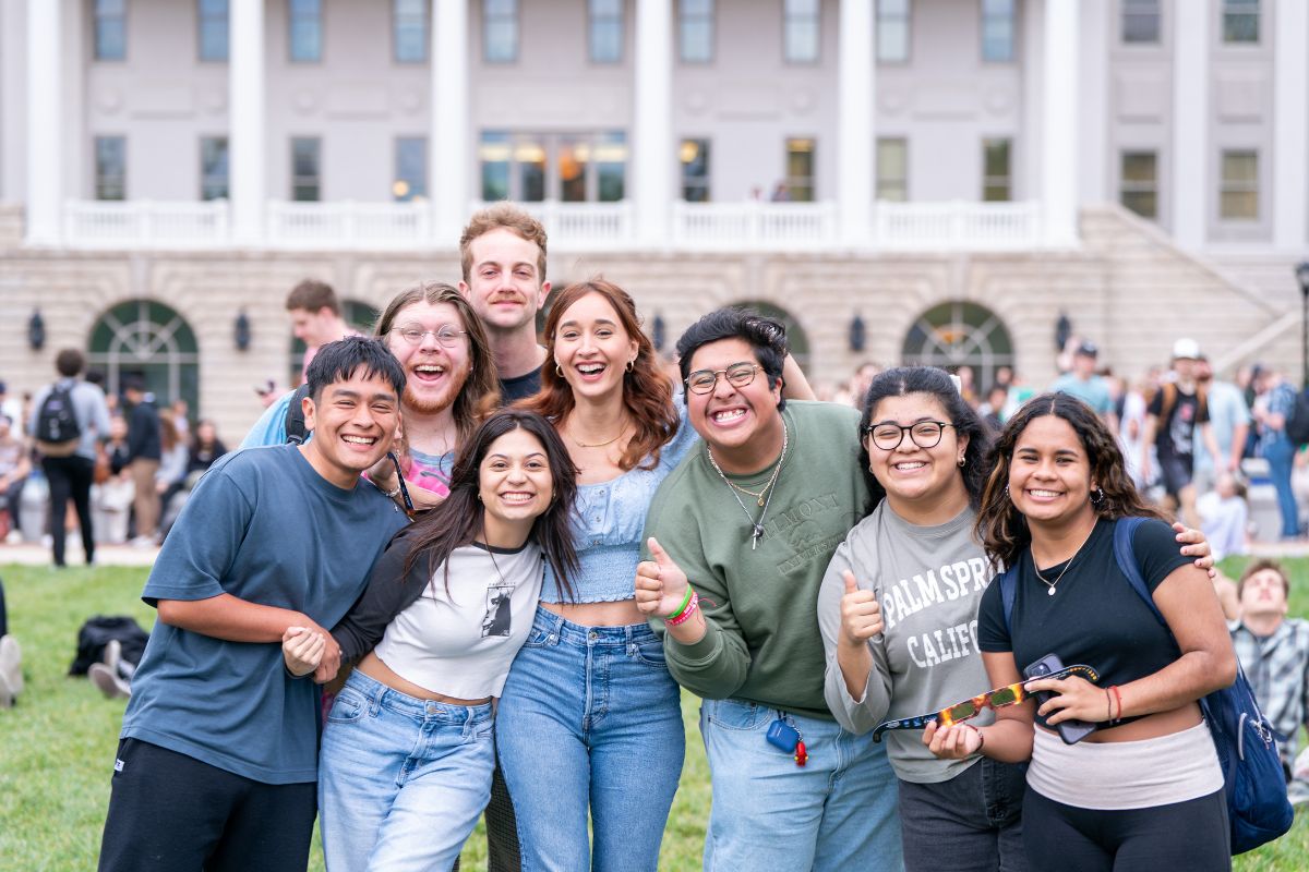 group of friends smile on Belmont's lawn