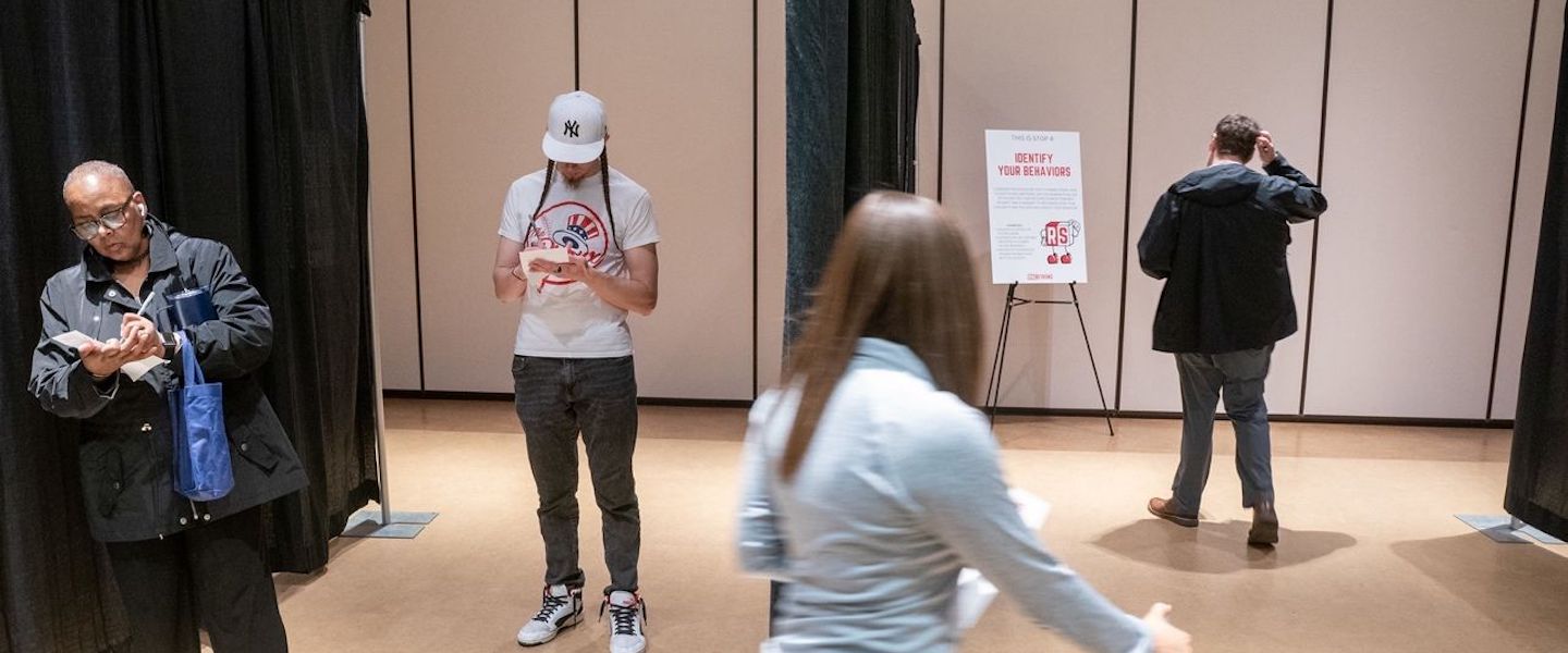 students and staff walk through "reframe lane" pop-up