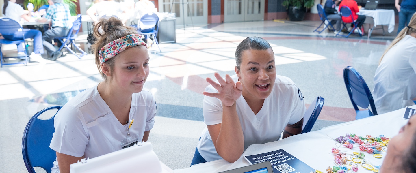 Two nursing students sitting at a table talking