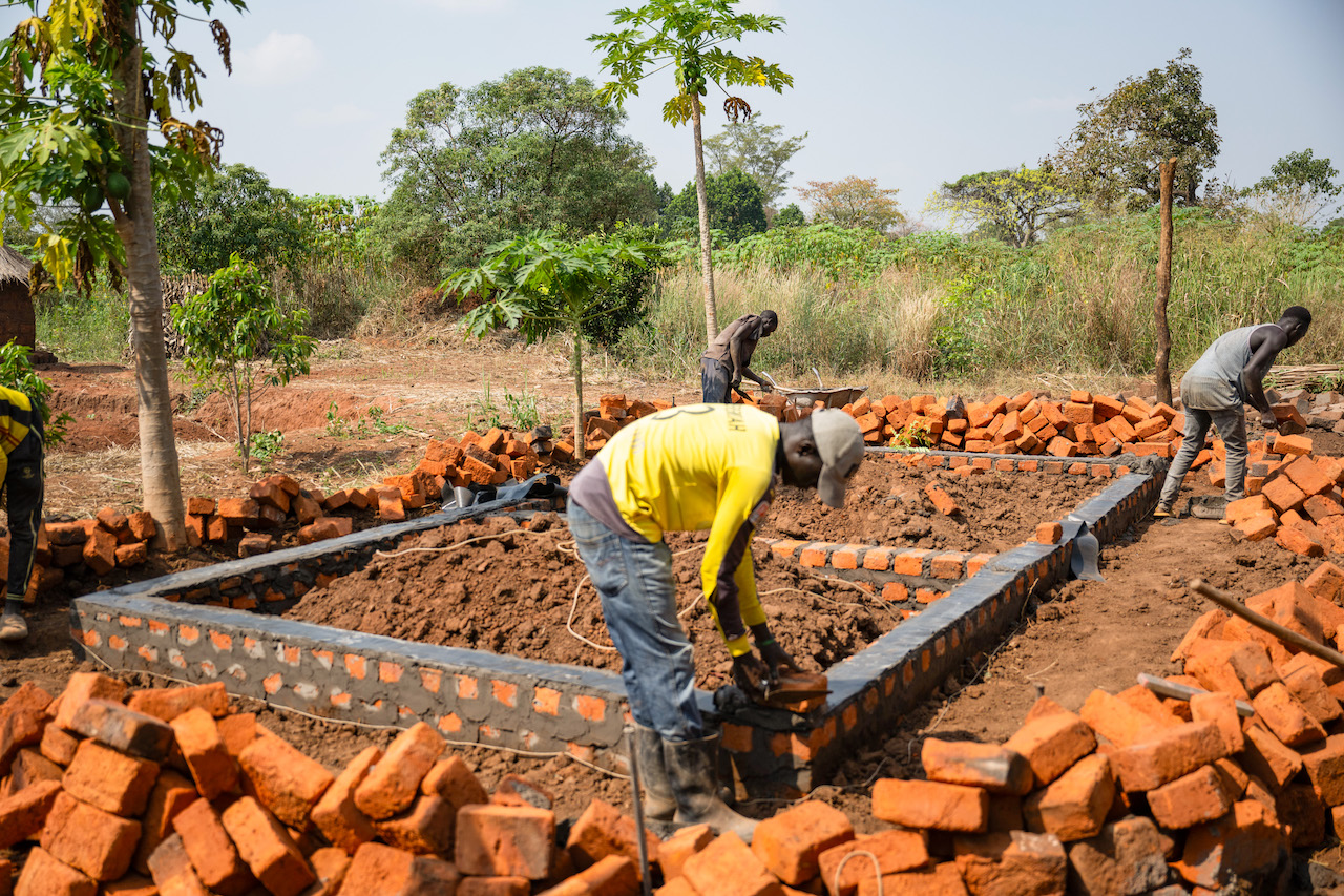 Man laying bricks for a house