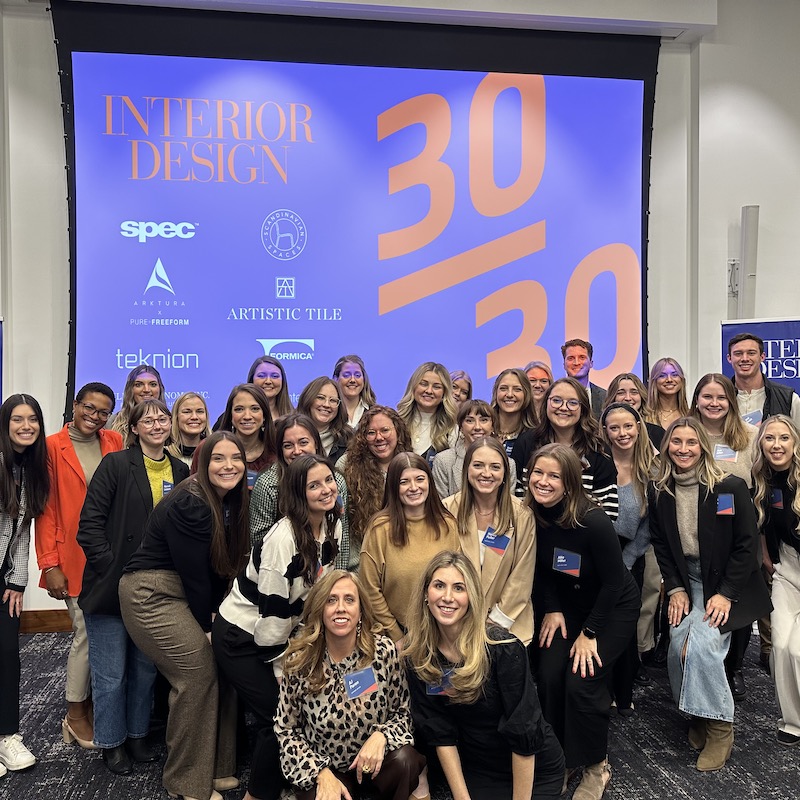 Group photo of the 30/30 participants in front of a screen with the logo on it