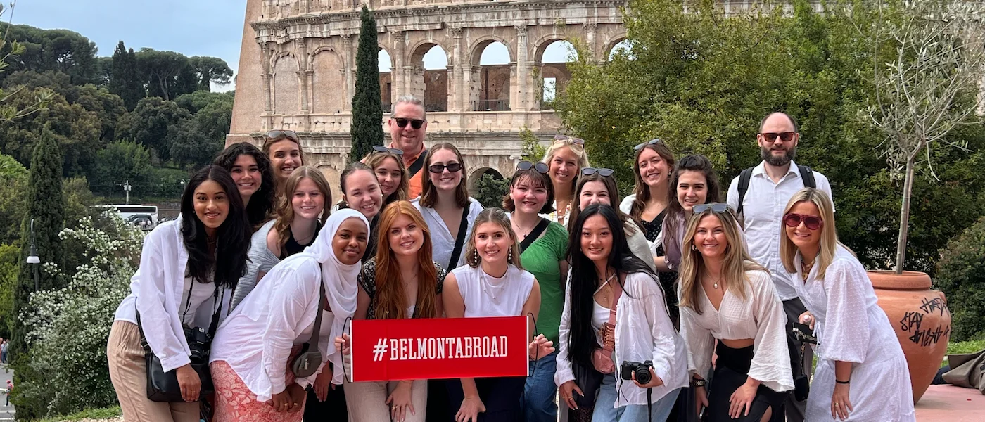Belmont students stand posed outside the Colosseum in Rome