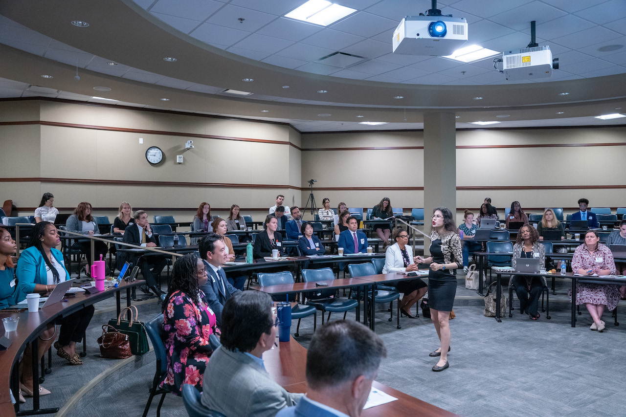 Yesha Yadav presenting to room of summit attendees