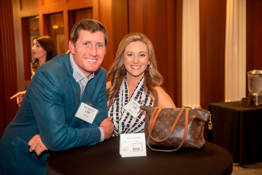 Alumna Kaley Bell and smiling at camera with companion