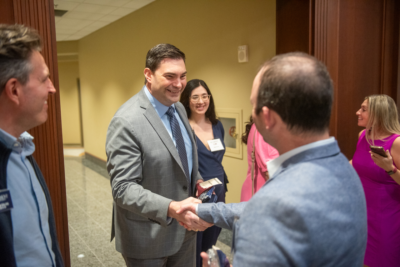 Law alumnus shaking hands with colleague