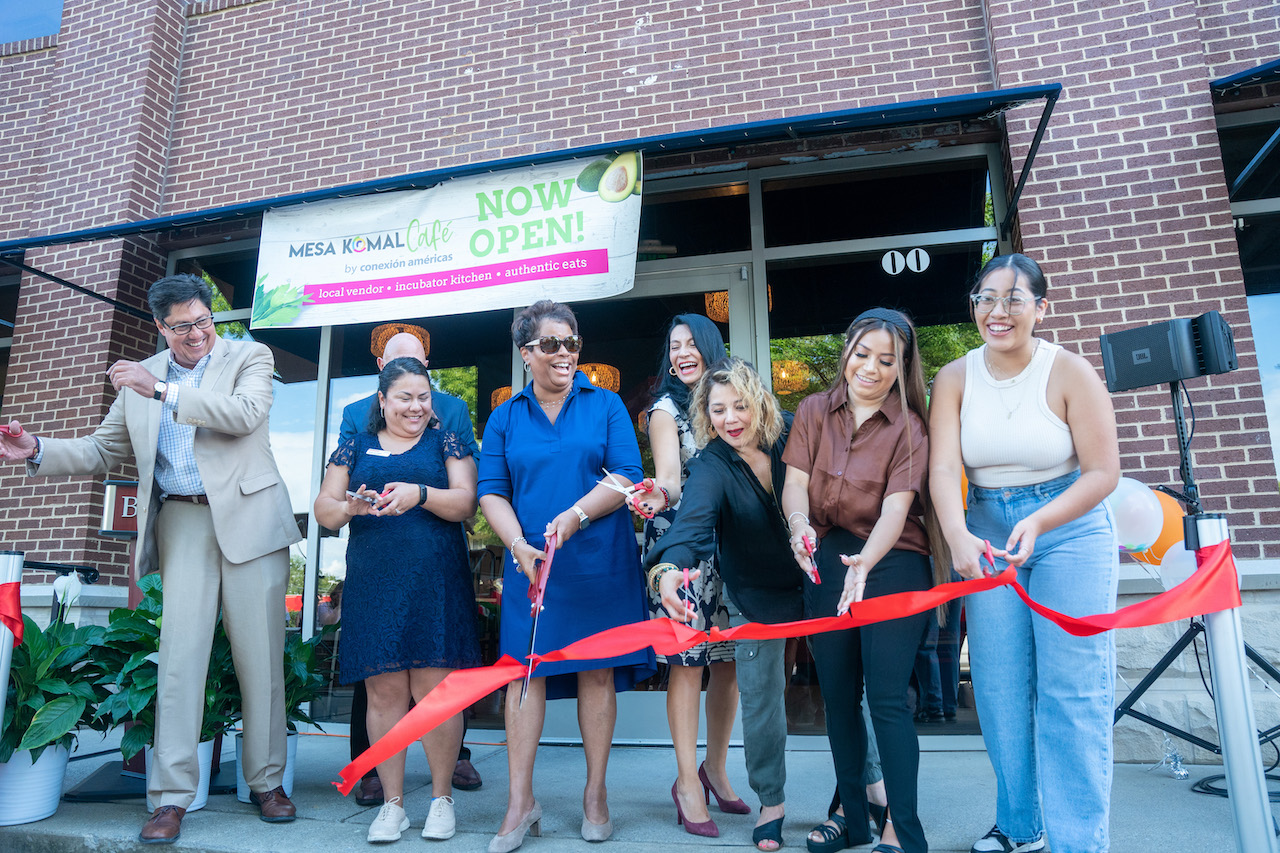 People cutting ribbon at the Mesa Komal Cafe opening