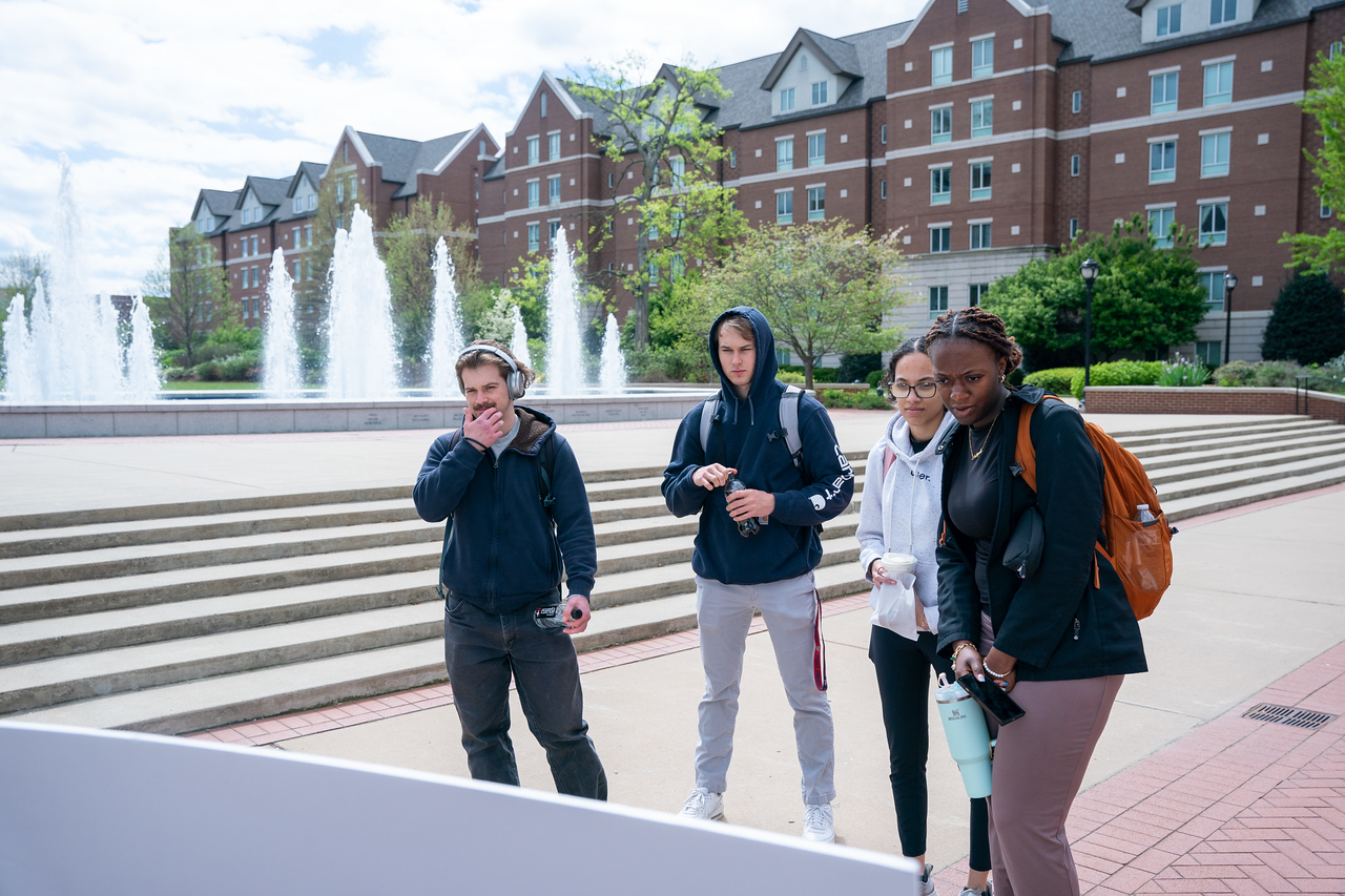 students looks at a pop-up event poster