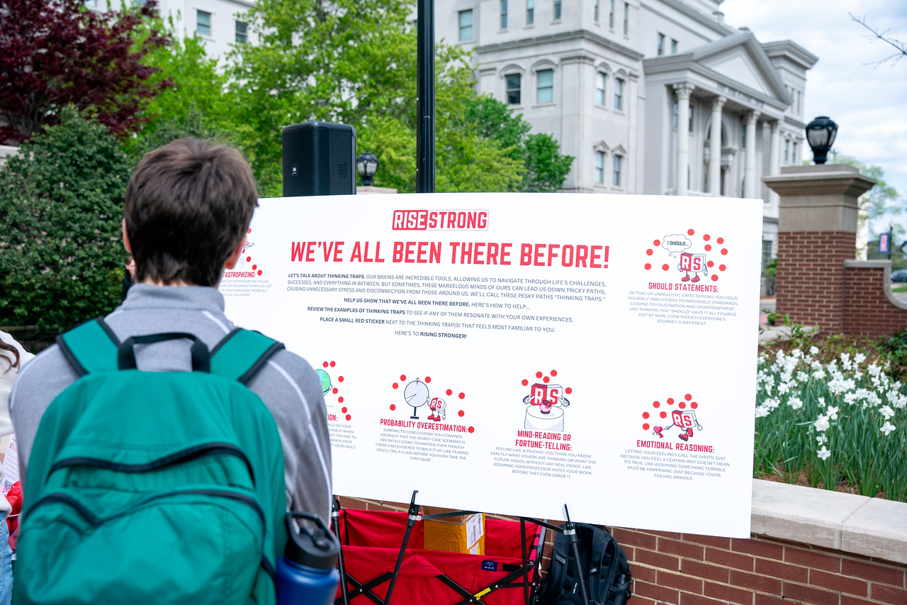 student looks at a pop-up event poster