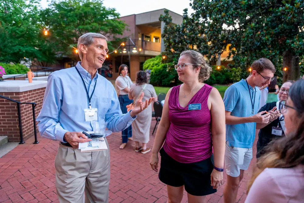 Man and woman talking at dessert reception