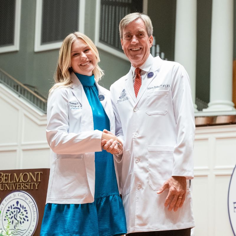 Luce and Dean Dr. Anderson Spickard in front of a podium