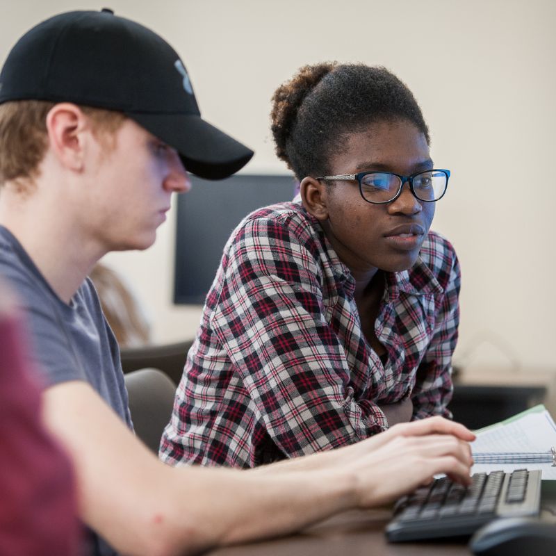 Two computer science students at a computer