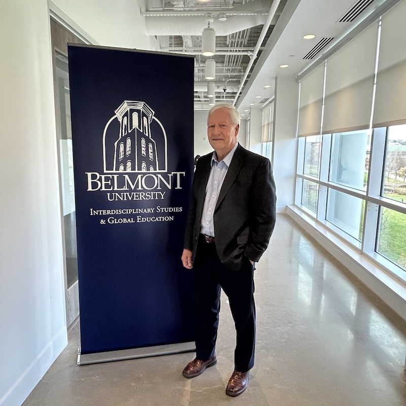 Dr. Fisher posing outside ISGE office at Belmont.