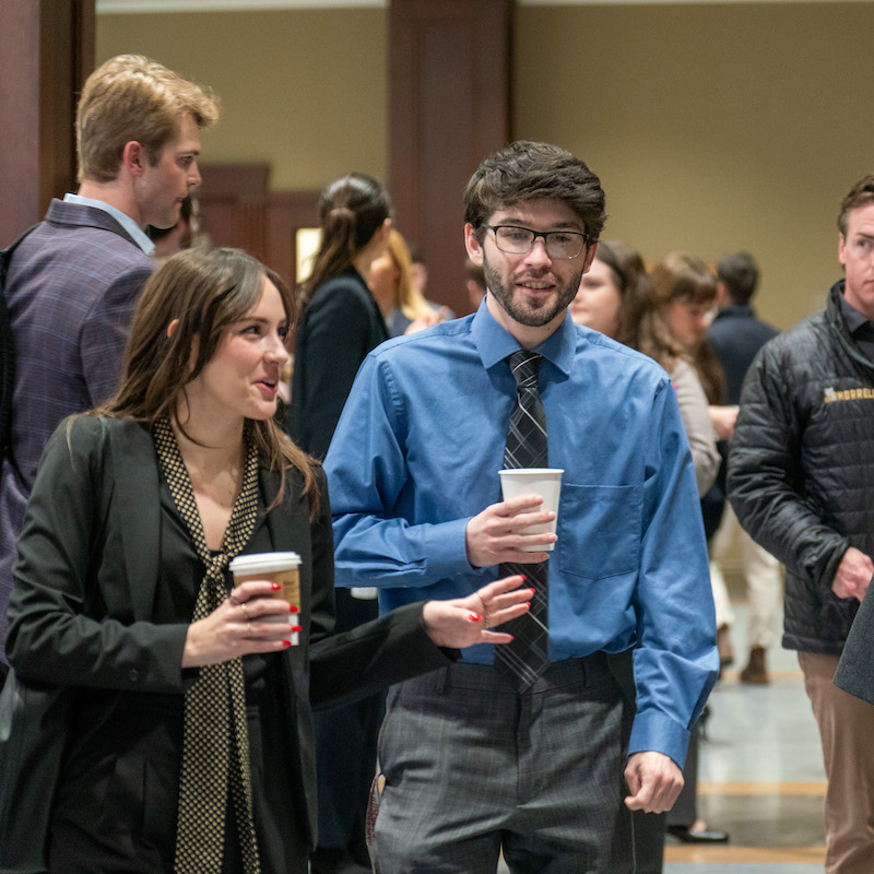 Law students talking with each other as they walk to class