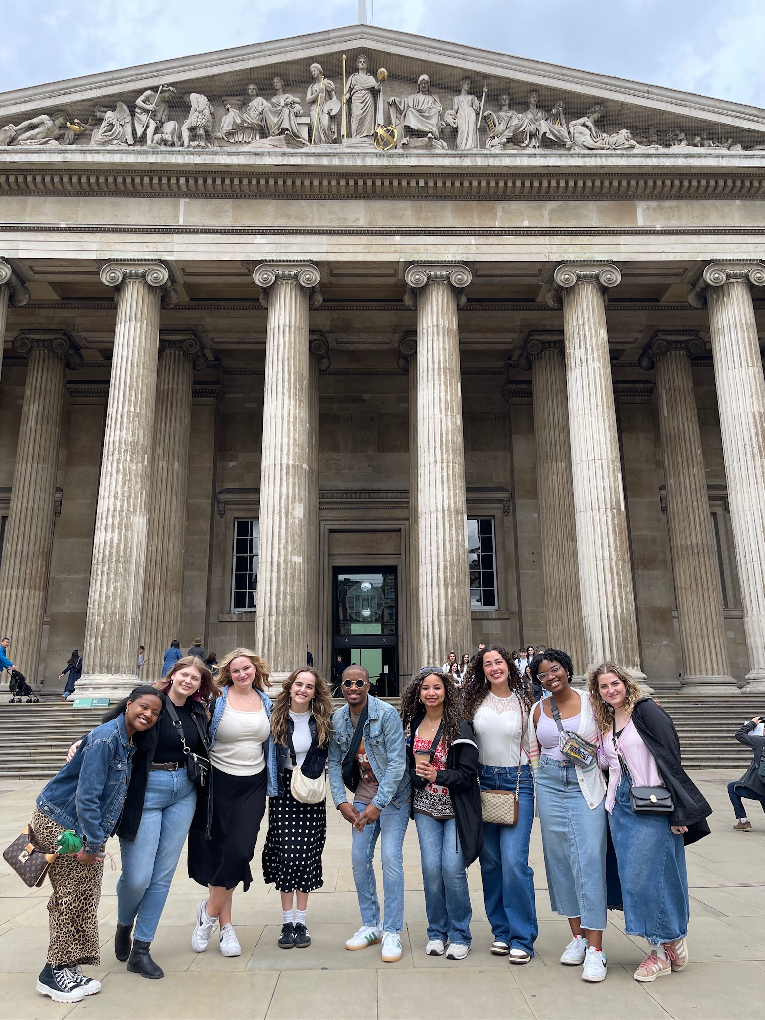 group poses in front of building