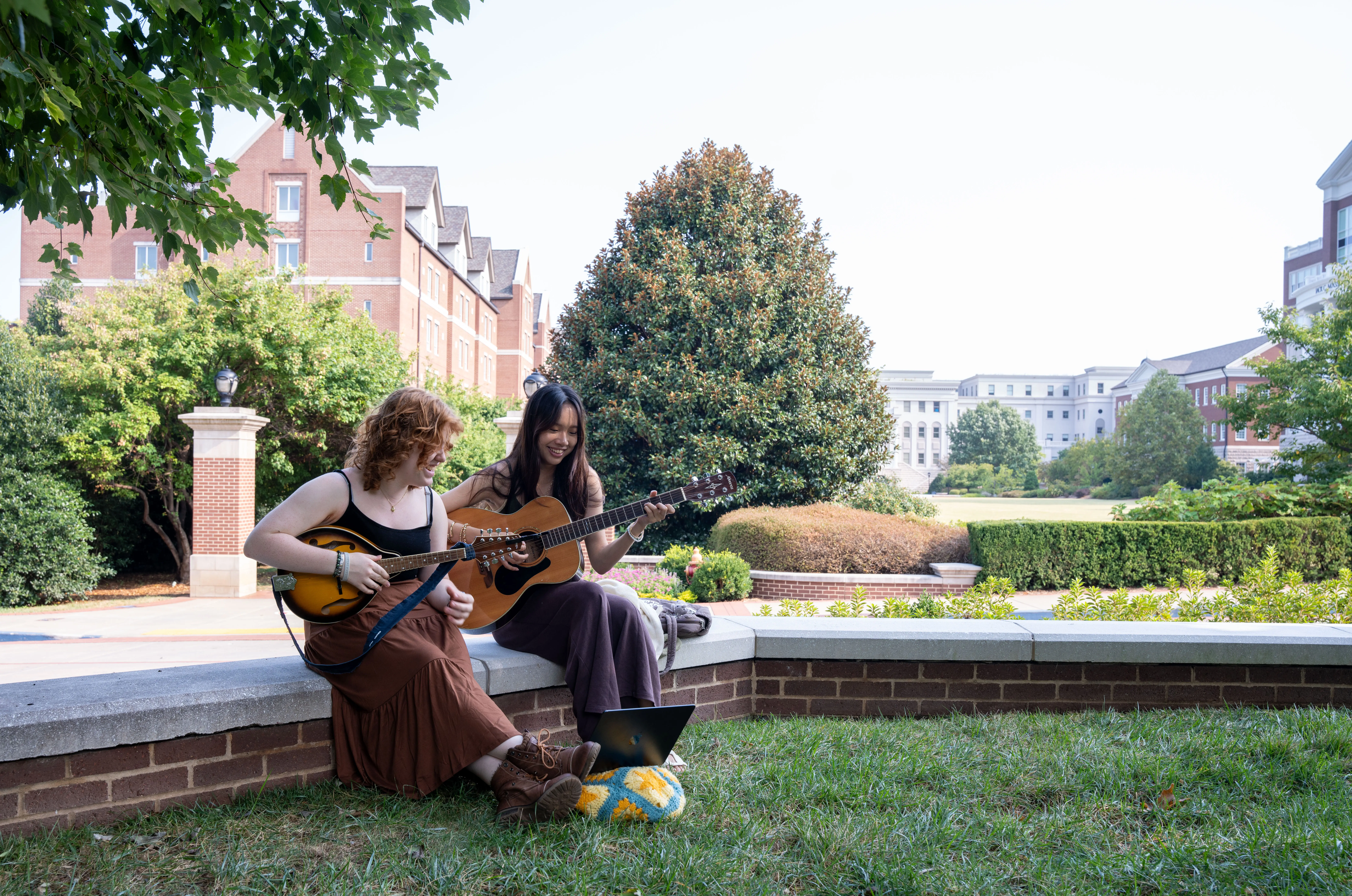 Students playing guitar together 