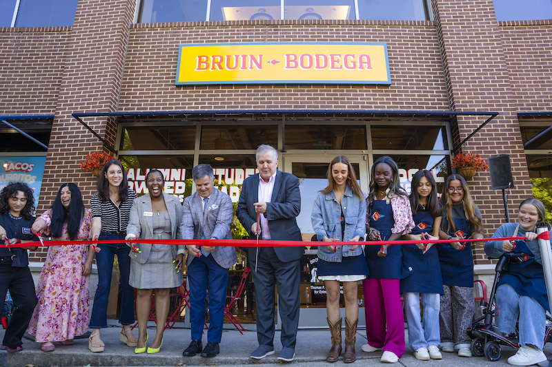 People cutting ribbon at bodega opening